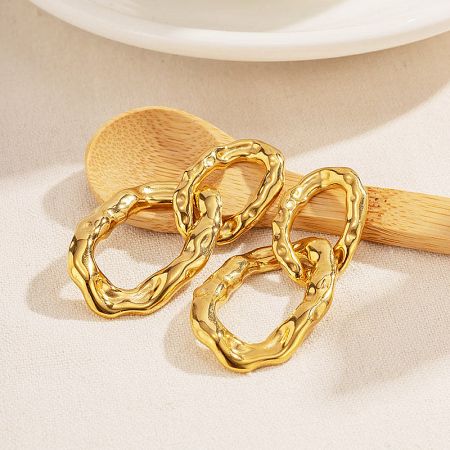 A pair of gold earrings with a unique wavy chain link design.