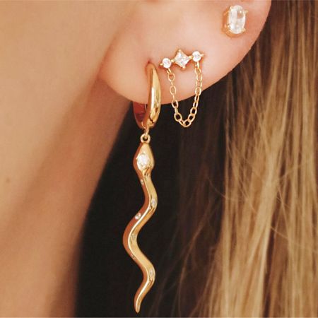 A set of 925 sterling silver earrings, with a focus on a unique wavy design adorned with zircons.