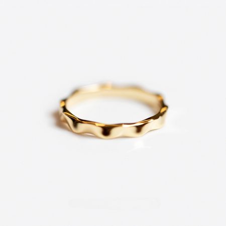 A detailed view of the 18K gold plated wavy ring, emphasizing its fluid and artistic design.