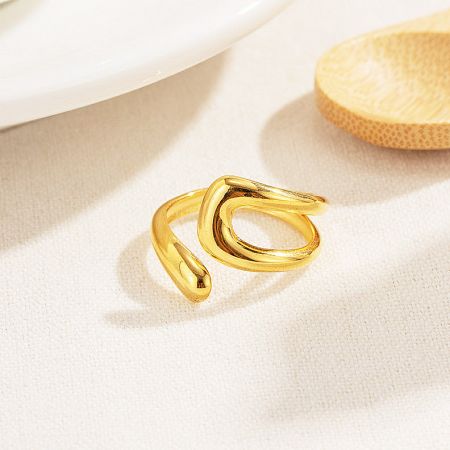 Detailed view of the gold wavy design ring from the adjustable set.