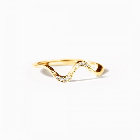 The Rhythmic Dance ring in a luxurious gold-plated finish, highlighting the wavy band and embedded crystals.