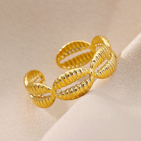 A close-up of a woven-style gold ring, emphasizing its craftsmanship.