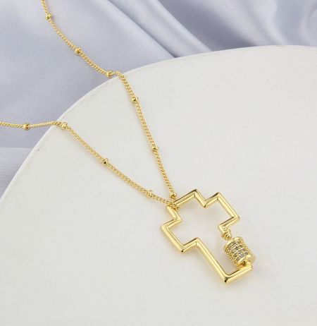 A unique gold zig-zag necklace pendant with gemstones, illustrating the design versatility of JR Fashion's custom jewelry.