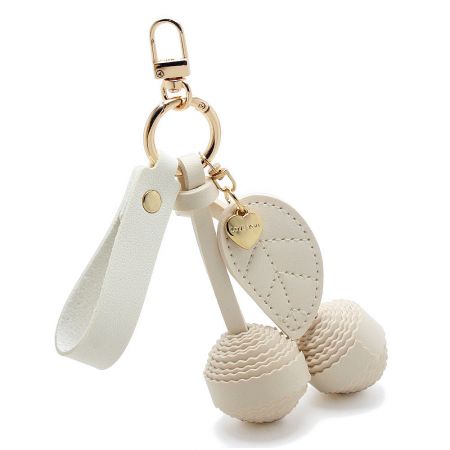 The elegant white PU leather cherry keychain, perfect for a clean look.