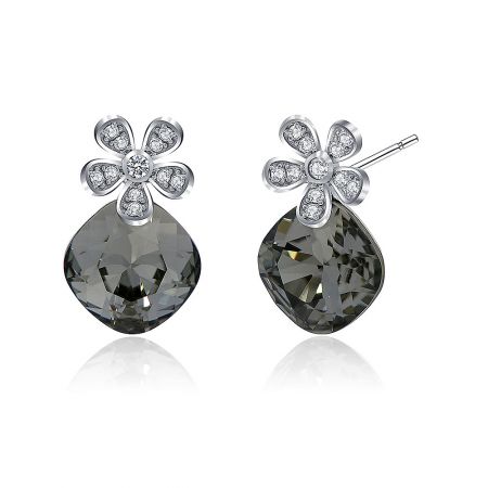 Detailed close-up of the gray teardrop gemstone and intricate silver flower decoration on the Swarovski crystal earrings.