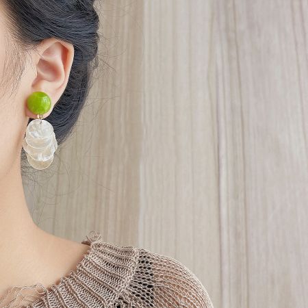 Close-up product photo of a green and white dangling earring from the 5-pair set.