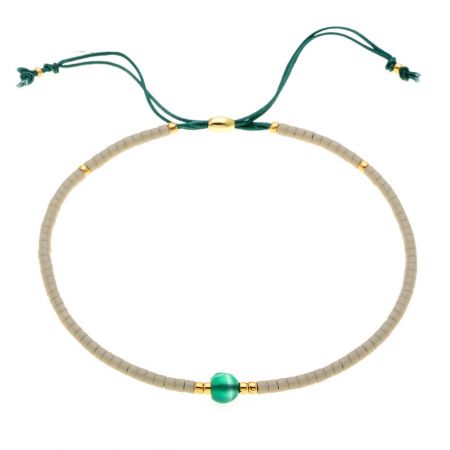 A stylish green cord bracelet featuring gold accents and a central green bead.