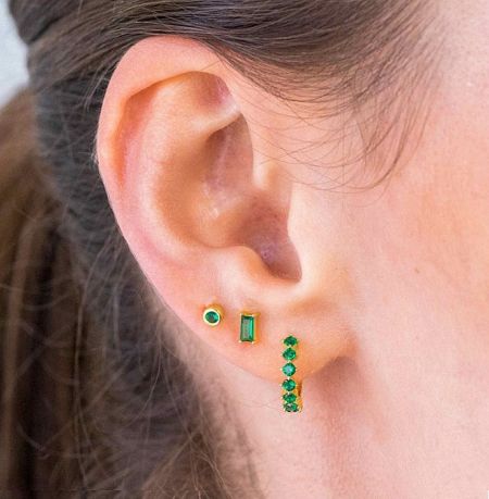 Model wearing the Emerald Dainty Tiny Huggie Hoop Earrings Set to showcase the fit and style.