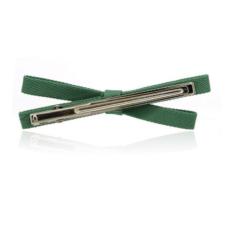 Detailed close-up of the green fabric hair clip, showing texture and craftsmanship.