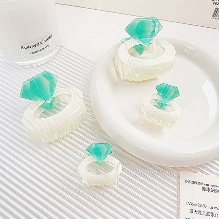 Lifestyle image featuring the acrylic hair clips alongside a decorative candle.