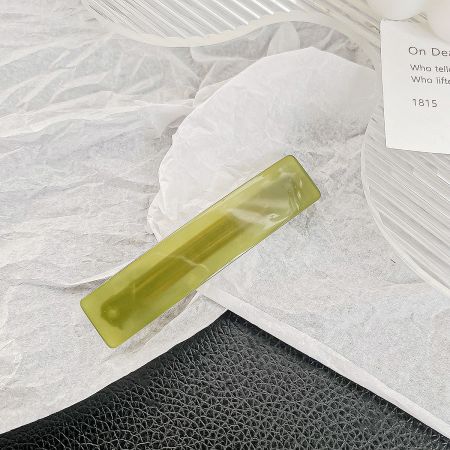 A single vibrant green rectangle hair barrette clip.