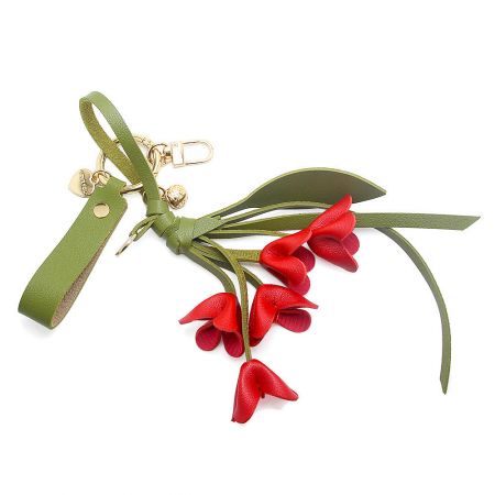 Red PU leather orchid keychain with gold hardware.