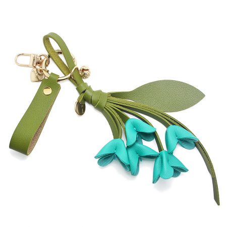 Blue PU leather orchid keychain with green strap.