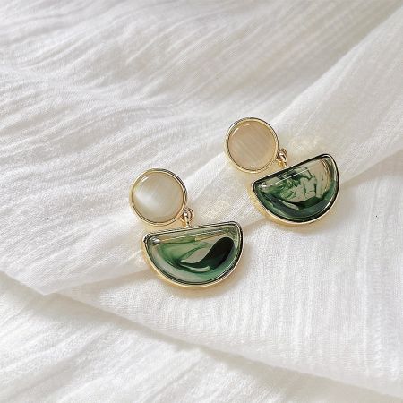 Unique gold earrings with beautiful green and white marbled stones.