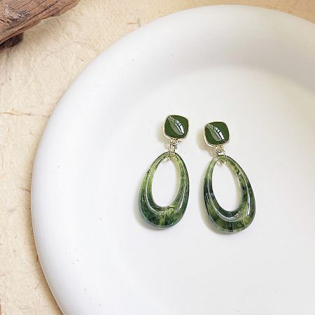 Front view of the 14k gold-plated green resin earrings, highlighting the detailed gold setting.