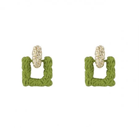 Close-up of a pair of green textured square earrings with elegant gold oval details.