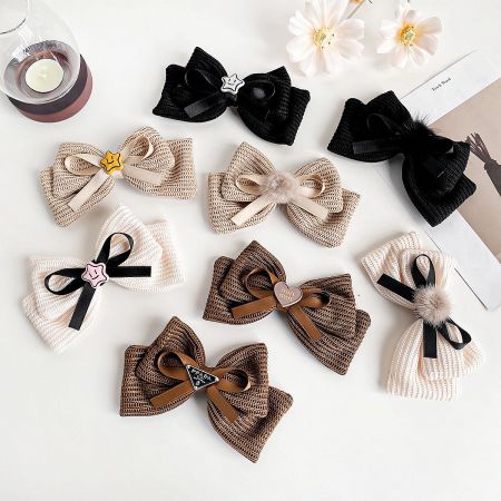 French Retro Knitted Bowknot Alligator Hair Clips (Set of 5) - A collection of French retro style knitted bowknot alligator hair clips in various colors and designs, including white, brown, and black with star and pom-pom details.