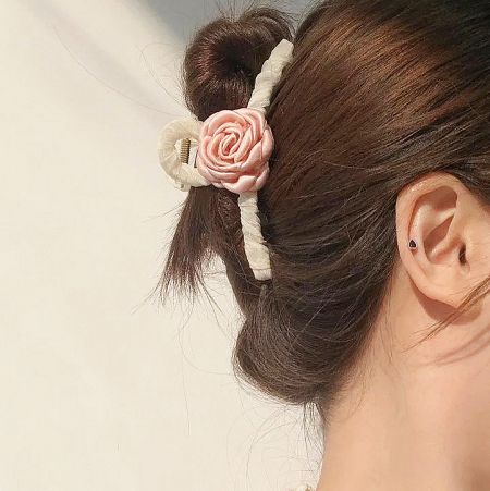 Model showcasing the pink camellia hair claw in her hair.