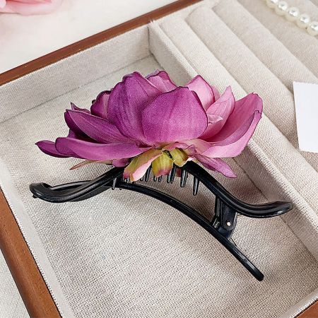 A beautiful pink lotus flower claw hairclip, perfect for a summer look.