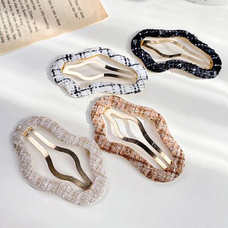 An assortment of four different stylish hair clips for girls.
