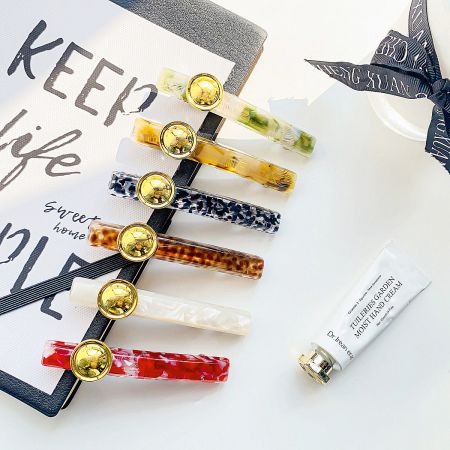 An elegant arrangement of leopard print hair clips alongside beauty products.