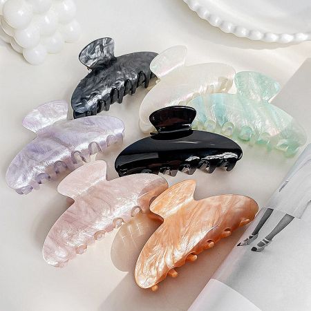 A collection of acrylic claw hair clips in various colors and styles.