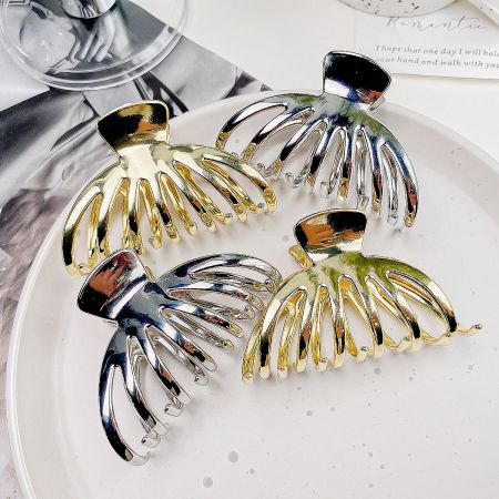 A collection of pumpkin-shaped metal hair clips available in both polished gold and sleek silver finishes.