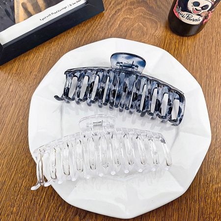 The black and transparent hair clips shown side-by-side for comparison.