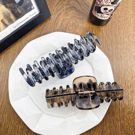 A pair of hair clips, highlighting their glossy finish and sturdy design.