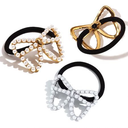 A set of three butterfly pearl charm hair ties, showcasing both gold and silver options.