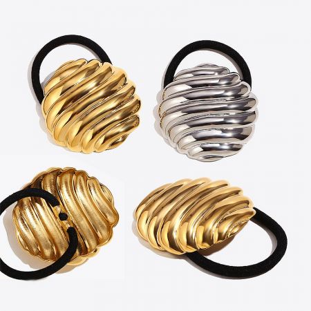 Angled view of the stainless steel hair ties in gold and silver, highlighting the striped texture.