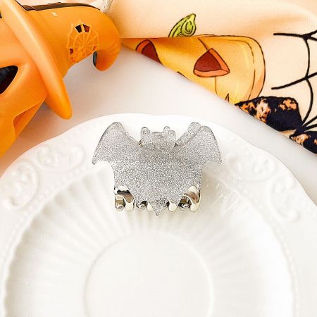 Sparkling silver glitter bat-shaped hair accessory.