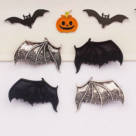 A collection of bat wing hair clips arranged for a spooky Halloween-themed product shot.