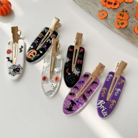 Two sets of Halloween 'Bride' themed hair clips in purple and white glitter.