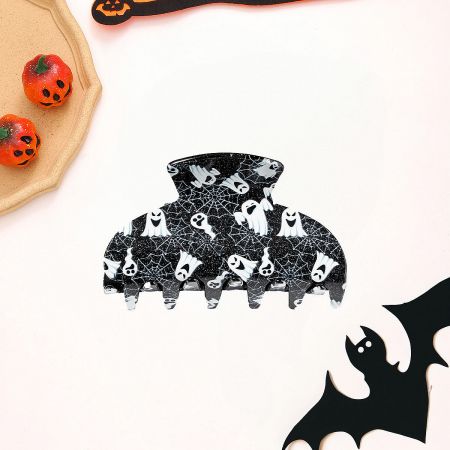 Close-up of a white ghost Halloween hair claw clip with a spider web design.