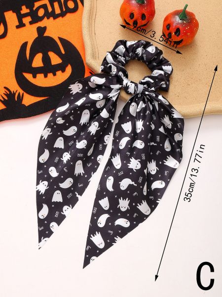 A black Halloween scrunchie featuring a cute white ghost pattern on its ribbon.