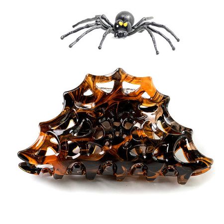 A black spider hair clip and an amber-colored claw clip for Halloween.