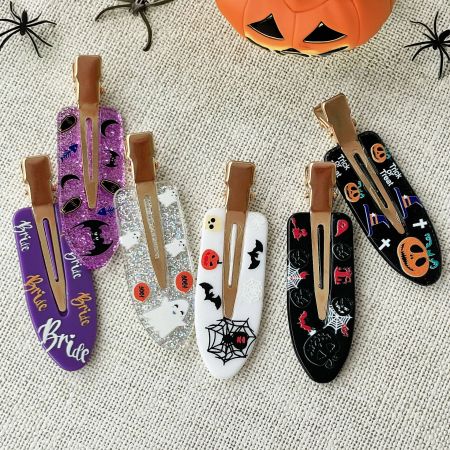 Assortment of acrylic Halloween hair clips featuring ghosts, pumpkins, and bats on a white background.
