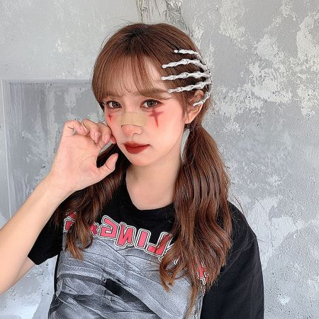 Model with dramatic Halloween skull makeup wearing the skeleton hand hair clip to complete the look.