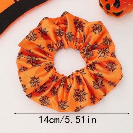 A bright orange Halloween scrunchie with a classic black spider web design.