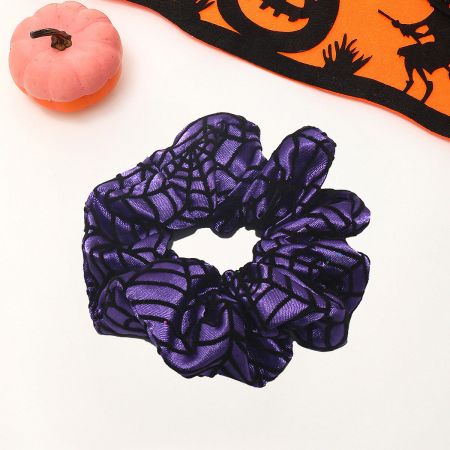 A purple Halloween scrunchie with a black spider web pattern.
