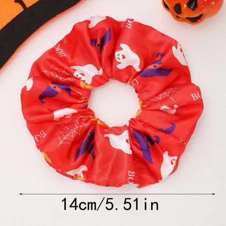 Close-up of a black Halloween scrunchie featuring a festive ghost, bat, and spider web pattern.