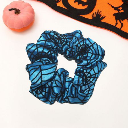 A blue Halloween scrunchie with a black spider web pattern.