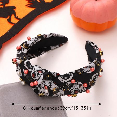 Black Halloween headband with a skull pattern, decorated with red, white, and gold beads.