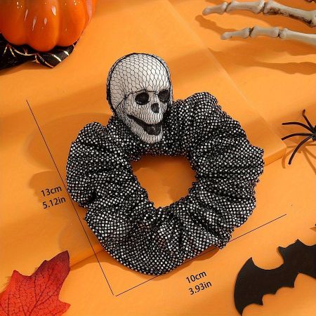 A Halloween skull scrunchie shown on a neutral background to highlight its design.