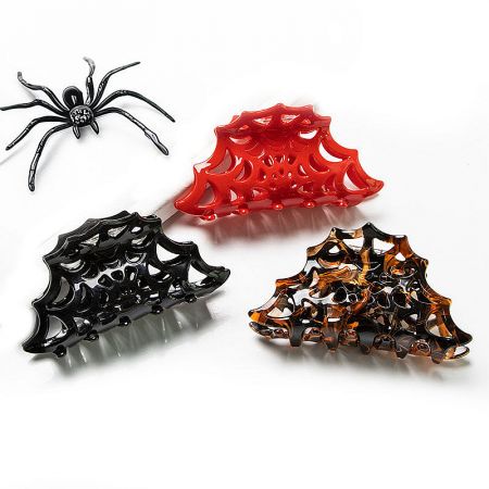 Three cobweb claw clips in black, red, and brown.