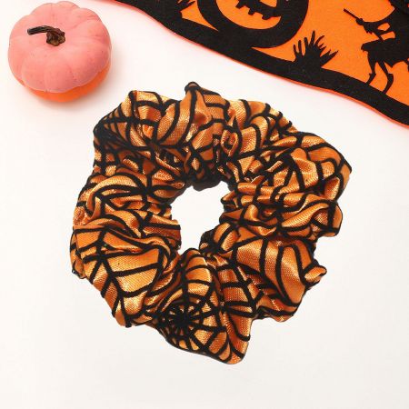 An orange Halloween scrunchie with a black spider web pattern.