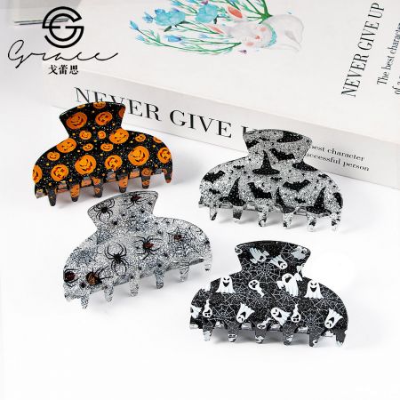 Various Halloween-themed hair claw clips displayed on a surface.