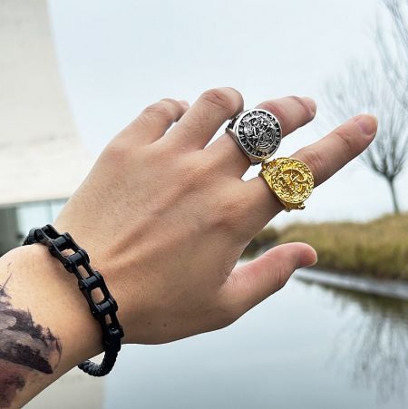 Lifestyle image of the gold plated stainless steel ring worn on a hand, demonstrating its style and fit.