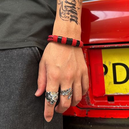 Lifestyle image showing the Tiger Head Ring worn on a hand, paired with other men's jewelry.